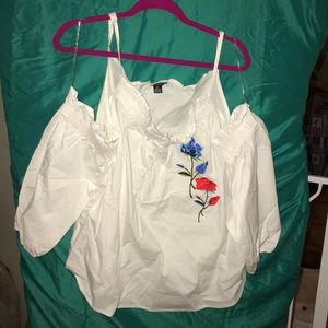 White cold shoulder top with embroidered roses.